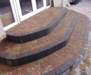 Roe Landscapes Paving & Landscaping Specialists, Dungiven, pvc door with steps paving black and red bricks