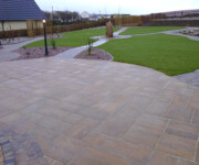 Roe Landscapes Paving & Landscaping Specialists, Dungiven, Paving and grass back garden with standing stone